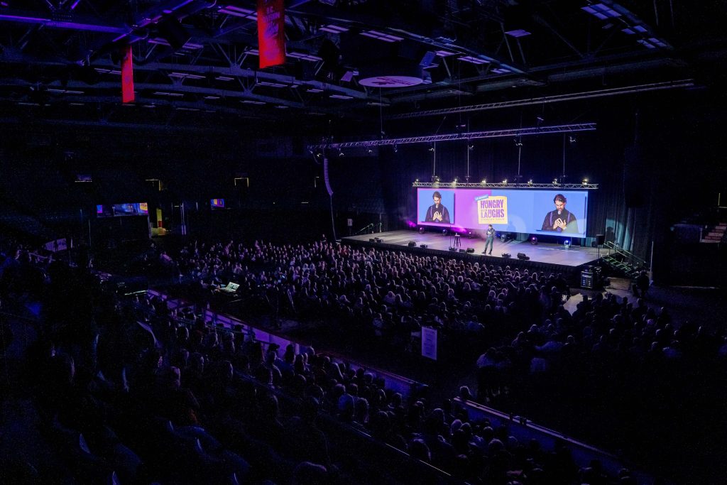 Alex performing at a Hungry for Laughs arena show