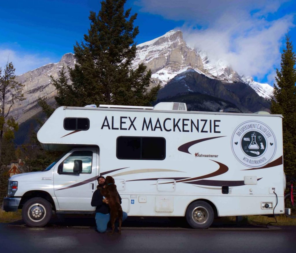 Alex with Finley beside their RV in Banff